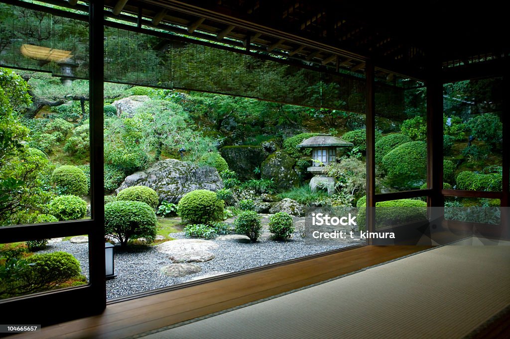 Japanese garden seen from inside a traditional tatami room.